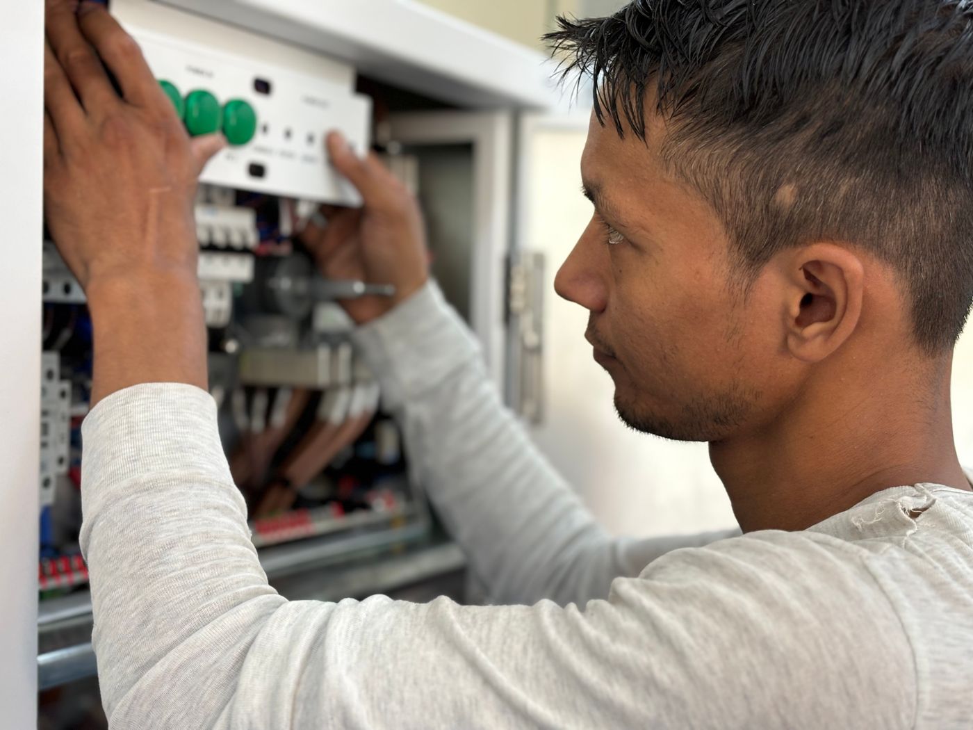 An electrician working on a residential electrical panel