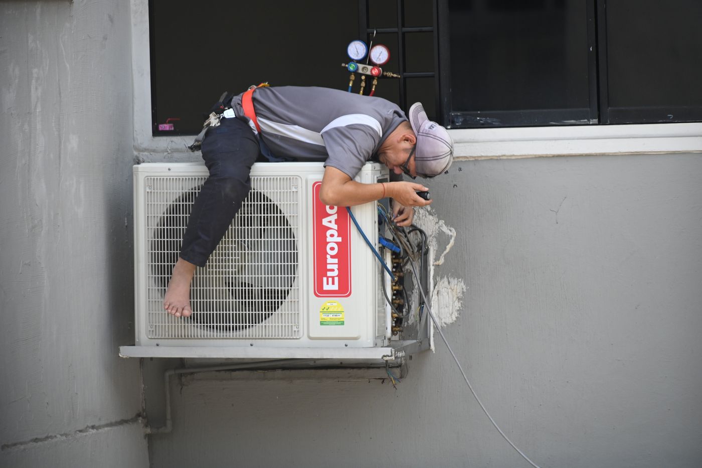An HVAC technician servicing an air-conditioning system
