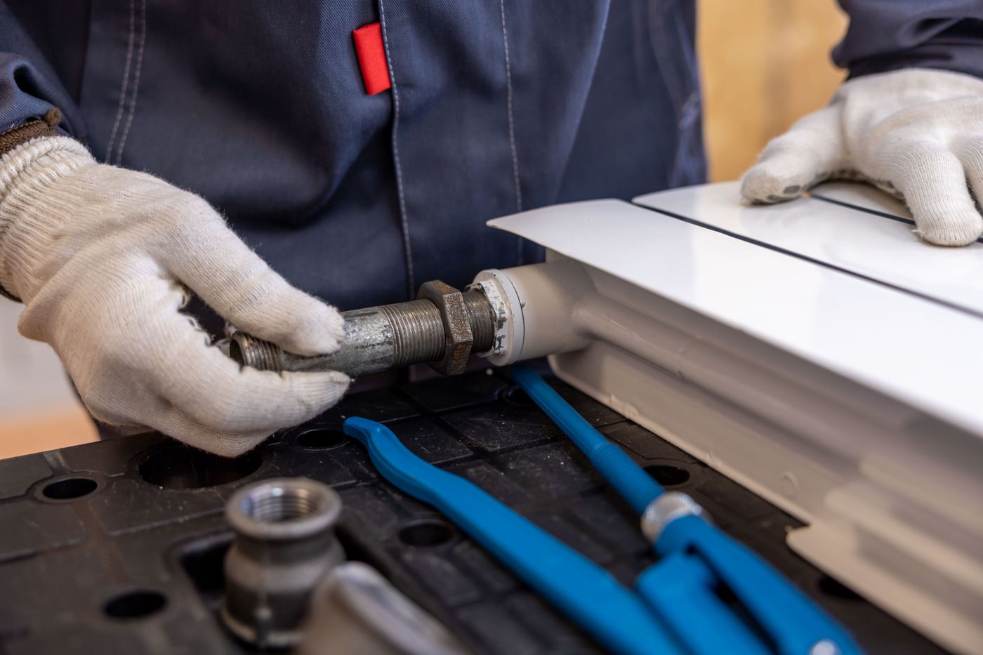 Professional plumber installing pipework for a customer
