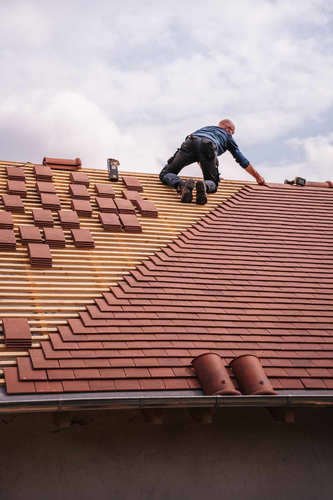 A professional roofer working on a residential property