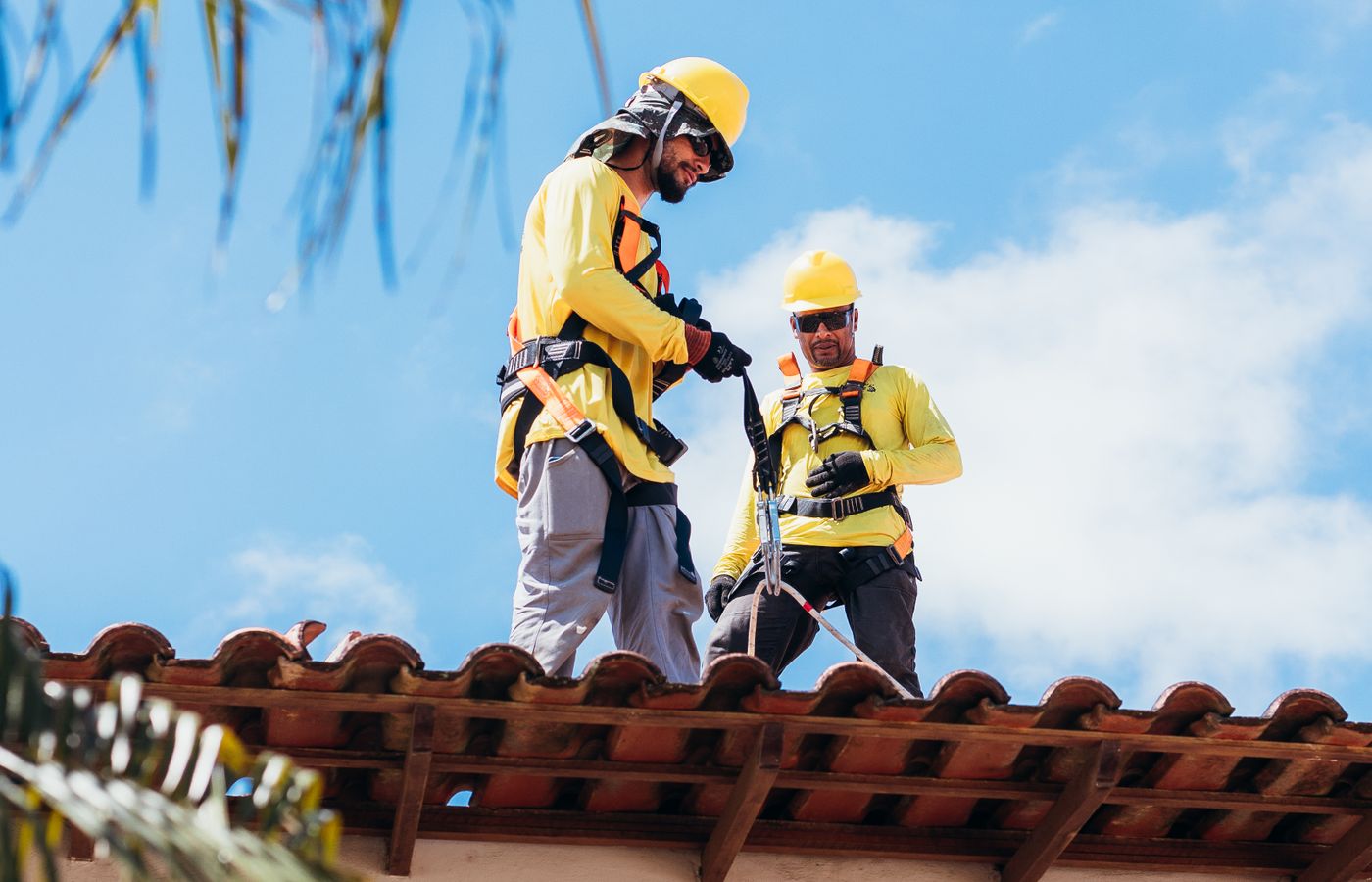 Roofer installing shingles on a residential roof